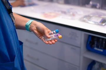 Nurse holding medical test tubes in laboratory setting