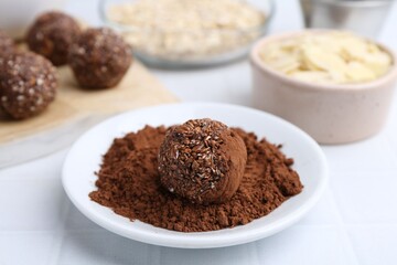 Making homemade candies. Chocolate balls and ingredients on white tiled table, closeup