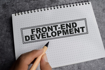 Concept of Front-end development write on book isolated on Wooden Table.