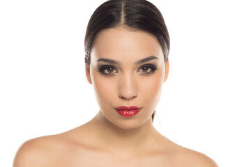 Portrait of young woman with glamorous makeup and red lipstick, looking confidently at camera,...