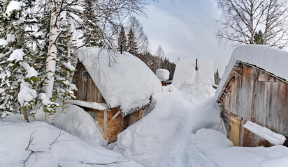 Russia. Kuznetsk Alatau. Winter view of the holiday village of Borisovka among the snow-covered impassable taiga on the banks of the Tom River.