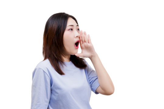 A young woman is shouting, cupping her hands around her mouth to amplify her voice, expressing excitement or calling out to someone.