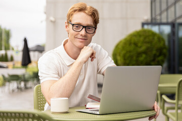 Redhead businessman generating ideas preparing workflow while doing his remote job
