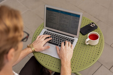 Young ginger freelancer typing on keyboard checking display