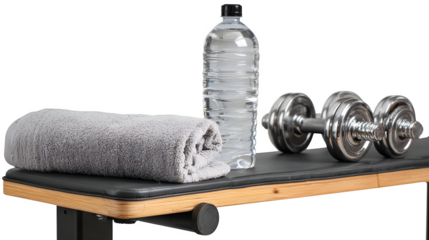 A close-up shot of a gym workout bench with a towel, water bottle, and dumbbells, symbolizing workout readiness