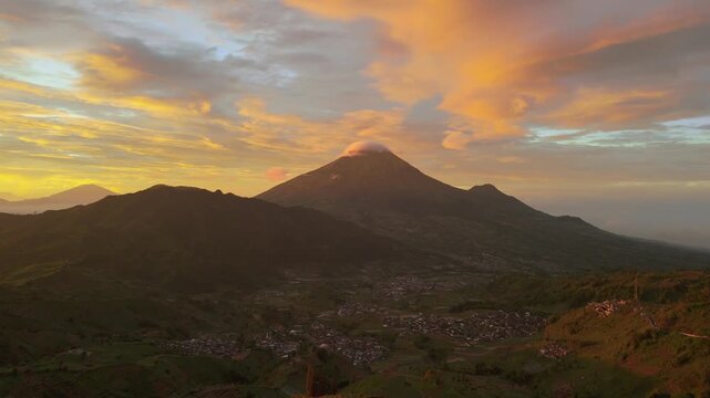 Amazing top view Sindoro mountain landscape at Dieng, Central Java with sunrise, majestic Sindoro mountain on background colorful sky on horizon at sunrise, Mount sunrise Trekking and travel concept.