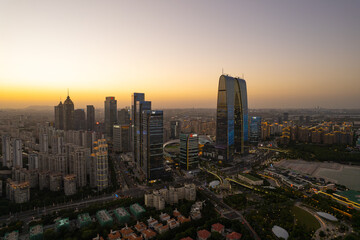 Cityscape panorama showing tall buildings in Hangzhou, China during twilight time.