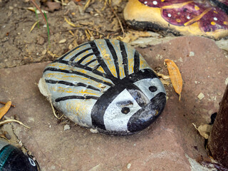 A rock painted to look like a butterfly
