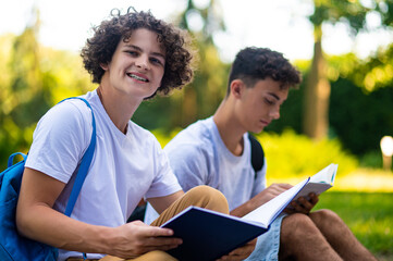 Teens learning lessons and looking involved while reading books