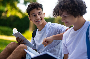 Teens learning lessons and looking involved while reading books