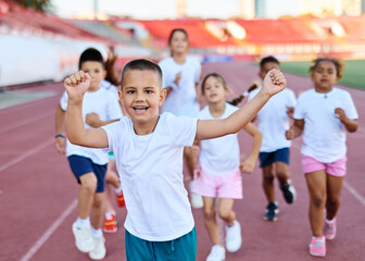 Young children having athletic exercise class running on the track, healthy lifestyle and children...