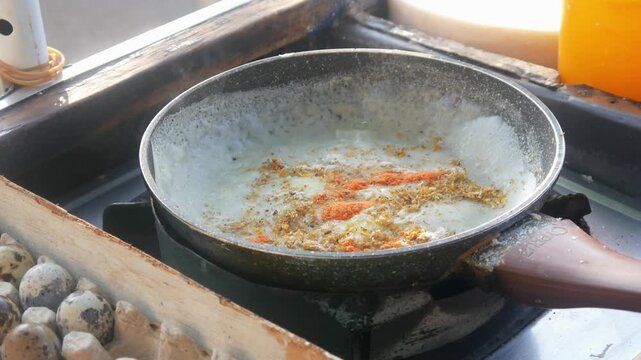 The process of cooking the Indonesian specialty papeda on a Teflon pan, sago dough is cooked until it thickens with a chewy, translucent texture. Cooking Papuan specialty