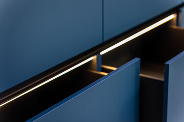 Light line. Open drawers. Blue fronts