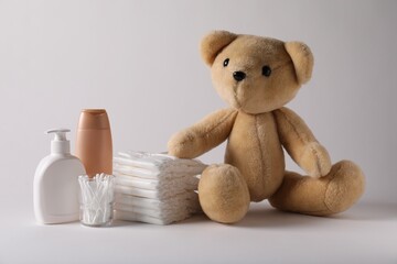 Baby accessories and body care products on light grey background