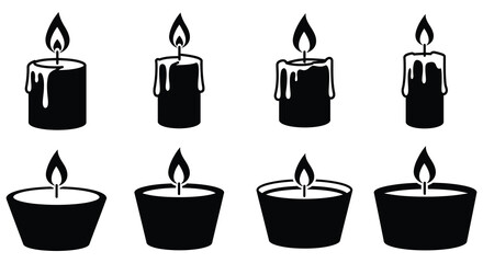 A collection of lit candles in various shapes and sizes on white background