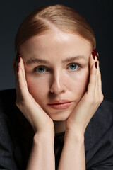 Portrait of beautiful woman on dark background, closeup