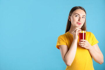 Woman with refreshing drink and straw on light blue background, space for text