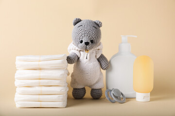Baby accessories and cosmetic products on beige background