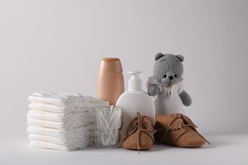 Baby accessories and body care products on light grey background
