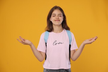 Student meditating before exam on orange background