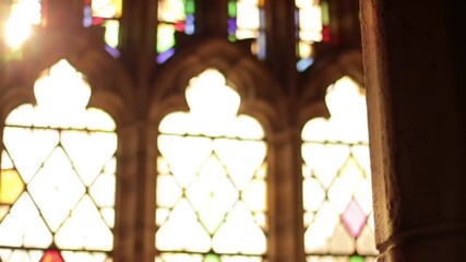 Colorful stained glass windows with intricate gothic architecture backlit by sunlight - Powered by Adobe