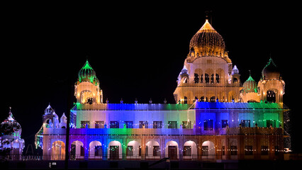 A brightly illuminated temple showcases a striking array of colorful domes and intricate architecture.