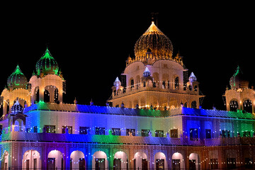 A brightly illuminated temple showcases a striking array of colorful domes and intricate architecture.
