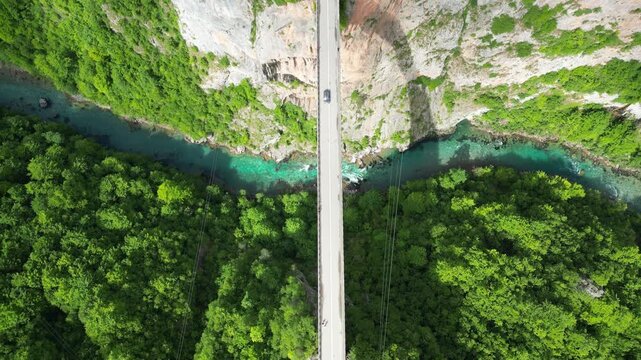 4K aerial drone video top-down over Đurđevića Tara Bridge pulling up to reveal Tara River canyon Durmitor Montenegro