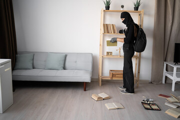 Female thief searching money stealing house. Criminal, house crime and breaking. Apartment, robbery...