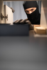 Female thief searching money stealing house. Criminal, house crime and breaking. Apartment, robbery...