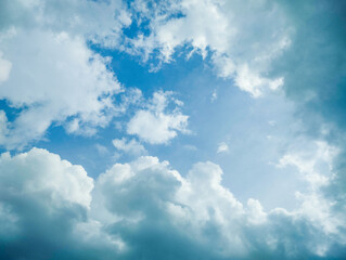 Bright Blue Sky with Soft White Clouds Framing the Horizon