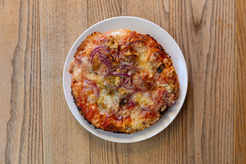 Mini Italian Pizza with Caramelized Onions on Wooden Table