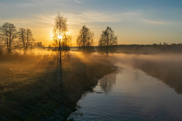 sunrise on the river with fog and trees 