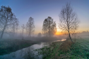 sunrise in the fog on the river