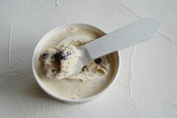 Delicious Cookies and Cream Ice Cream Served in a White Bowl on a Minimal Background Highlighting Sweet Frozen Dessert and Indulgent Snack