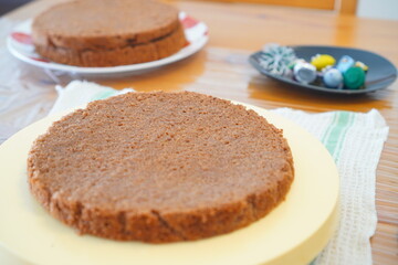 Plain Chocolate Sponge Cake Layer on Plate for Baking Preparation and Homemade Dessert Creation in a Simple Minimal Style Background
