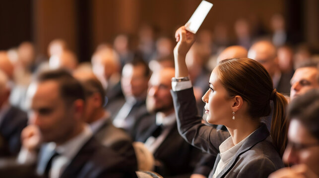 A close-up of a bidder subtly raising their numbered paddle to place a bid. 