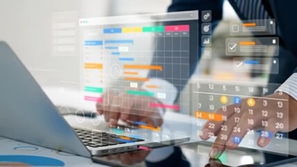Hands interacting with a digital calendar and project management interface on a laptop and tablet - Powered by Adobe