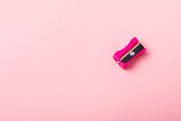 Fototapeta premium Pencil sharpener on bright colored background. Pencil and pencil shavings. Stationery. School supplies. School products. Flat lay. Place for text. copy space.