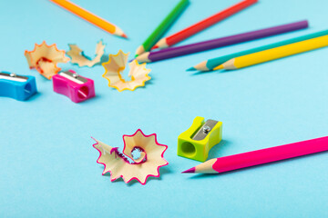 Pencil sharpener on bright colored background. Pencil and pencil shavings. Stationery. School...