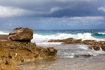 Stormy Waves Crashing Against Rocky Tropical Shore