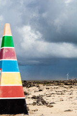 Colorful Landmark Obelisk by Rocky Coastline