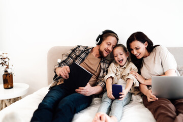 Happy family leaning in to look at phone screen, joyful digital bonding moment showing connection,...
