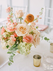 Beautiful floral arrangement on a table for a wedding reception during the afternoon in a bright venue