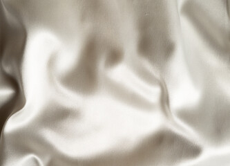 Closeup of smooth beige satin fabric
