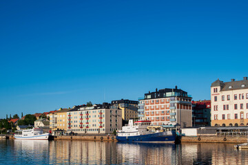A piece of the marina in Harnosand on a summer evening with blue skies