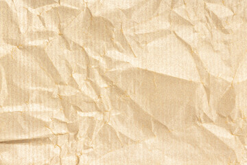 Crumpled Kraft paper texture background. Light golden brown color