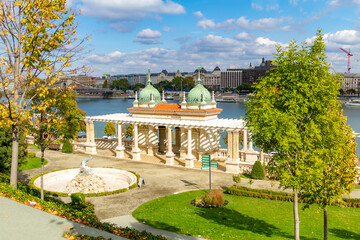 Elevated view of V&aacute;rkert Baz&aacute;r's neo-Renaissance terraces and pavilions at Castle Hill base, with Triton Fountain, Danube River and Pest bank under autumn sky. Budapest, Hungary.

