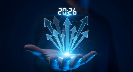 Naklejka premium Futuristic digital display of upward arrows and year 2026 emerging from a hand