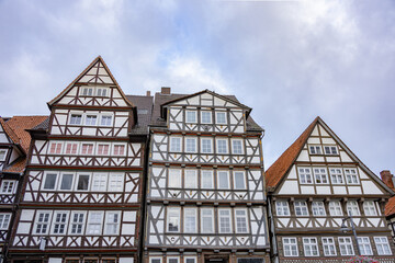 Traditional half timbered houses with red tiled roofs in Hann Munden, Germany under cloudy sky